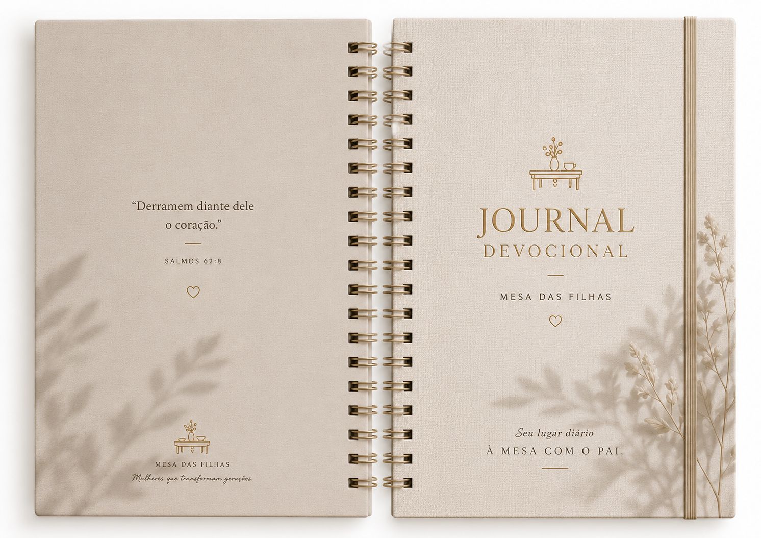 Journal devocional em tecido rosé com detalhes dourados sobre superfície creme